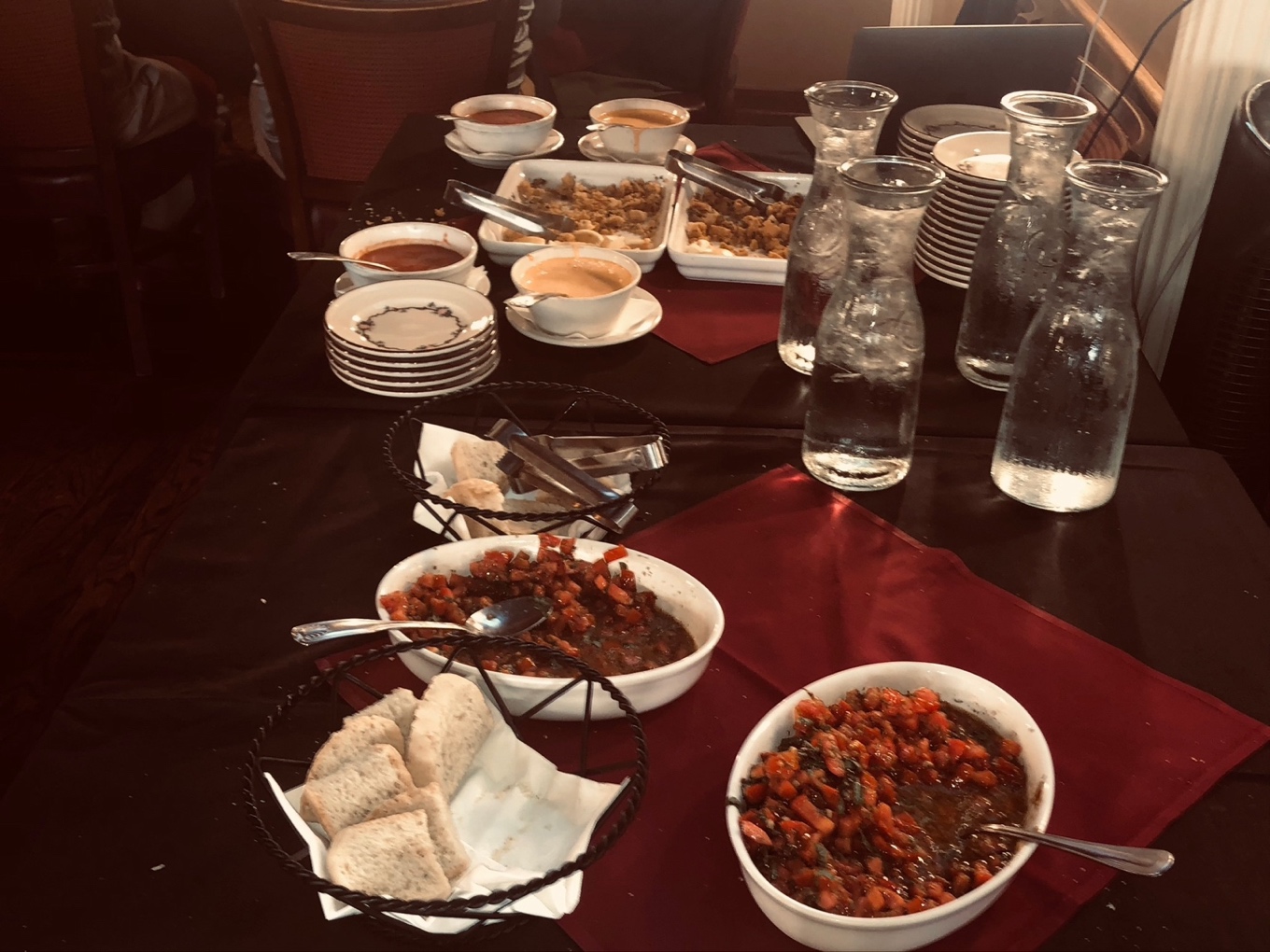 A table with plates and bowls of food

Description automatically generated