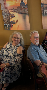 A group of people sitting at a table

Description automatically generated