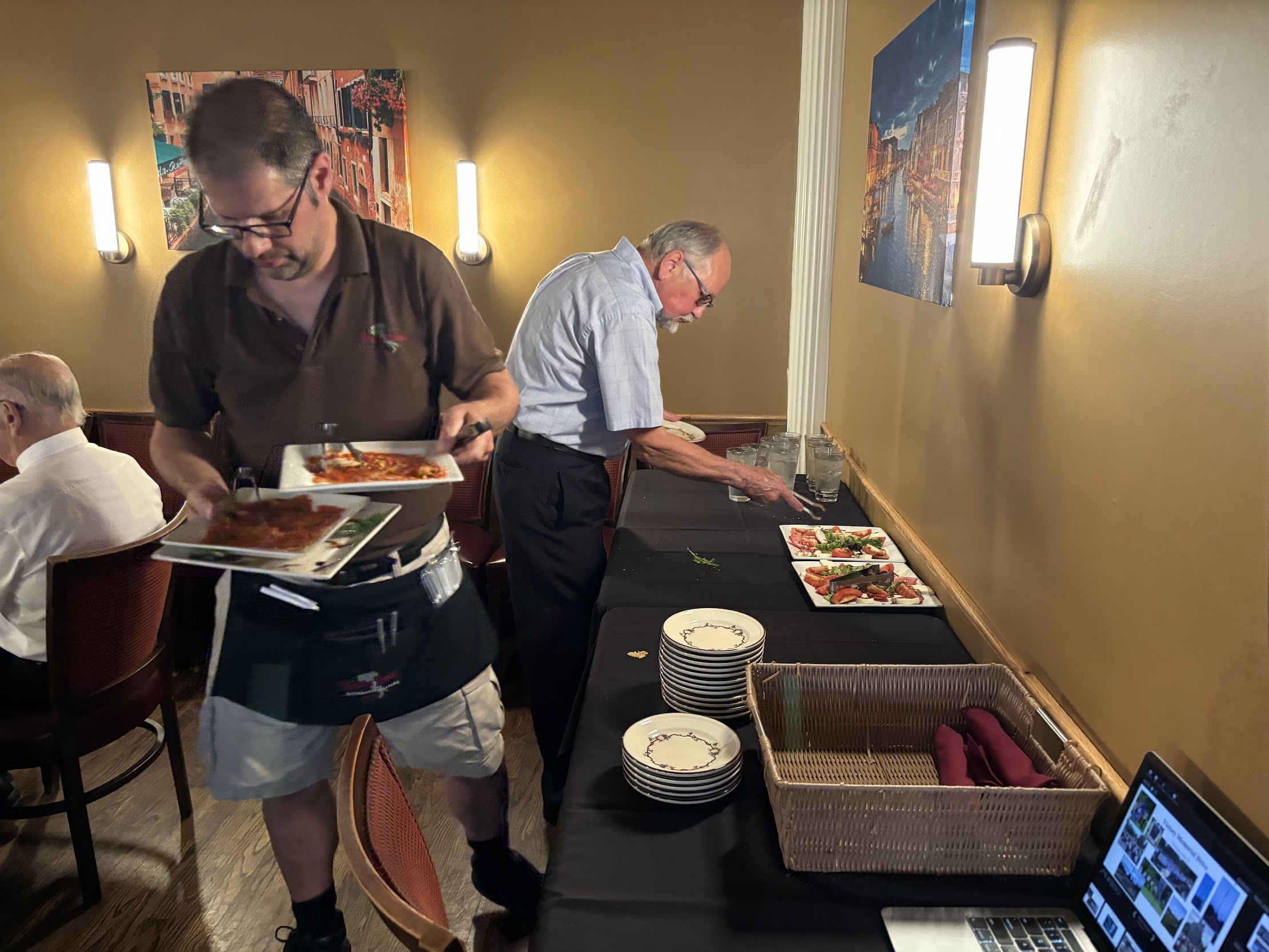A person holding plates of food

Description automatically generated