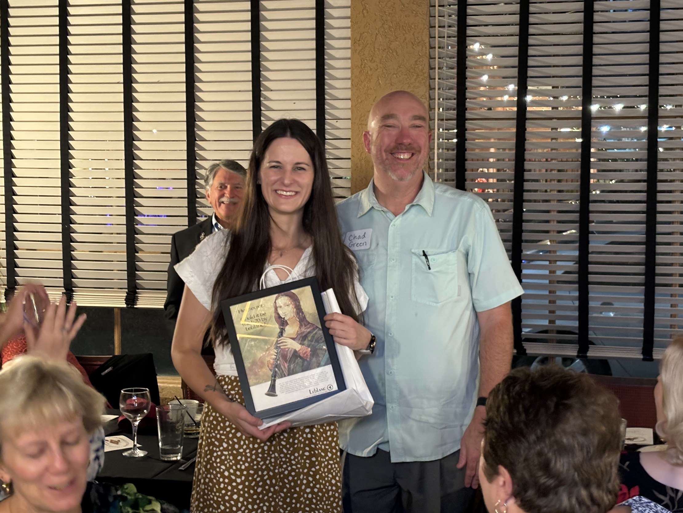 A person and person holding a picture

Description automatically generated