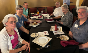 A group of people sitting at a table

Description automatically generated