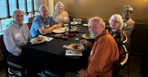A group of people sitting at a table

Description automatically generated