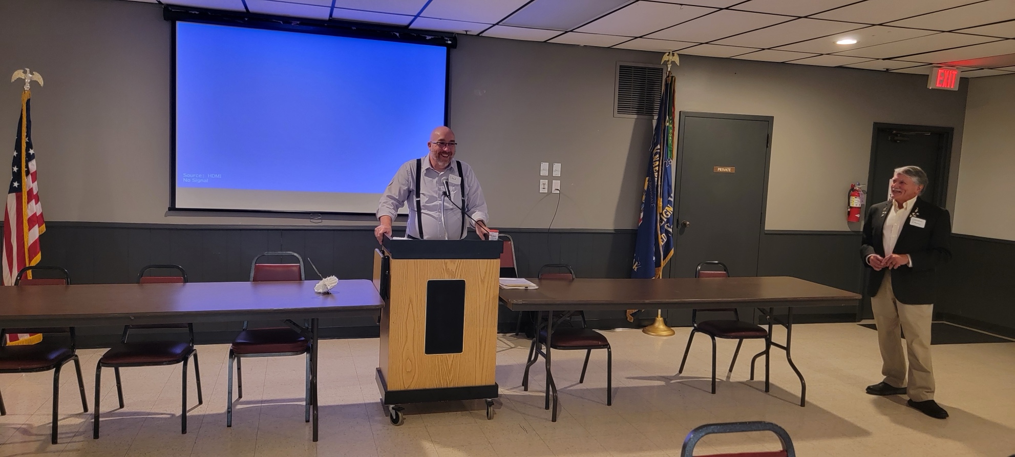 A person standing at a podium
AI-generated content may be incorrect.