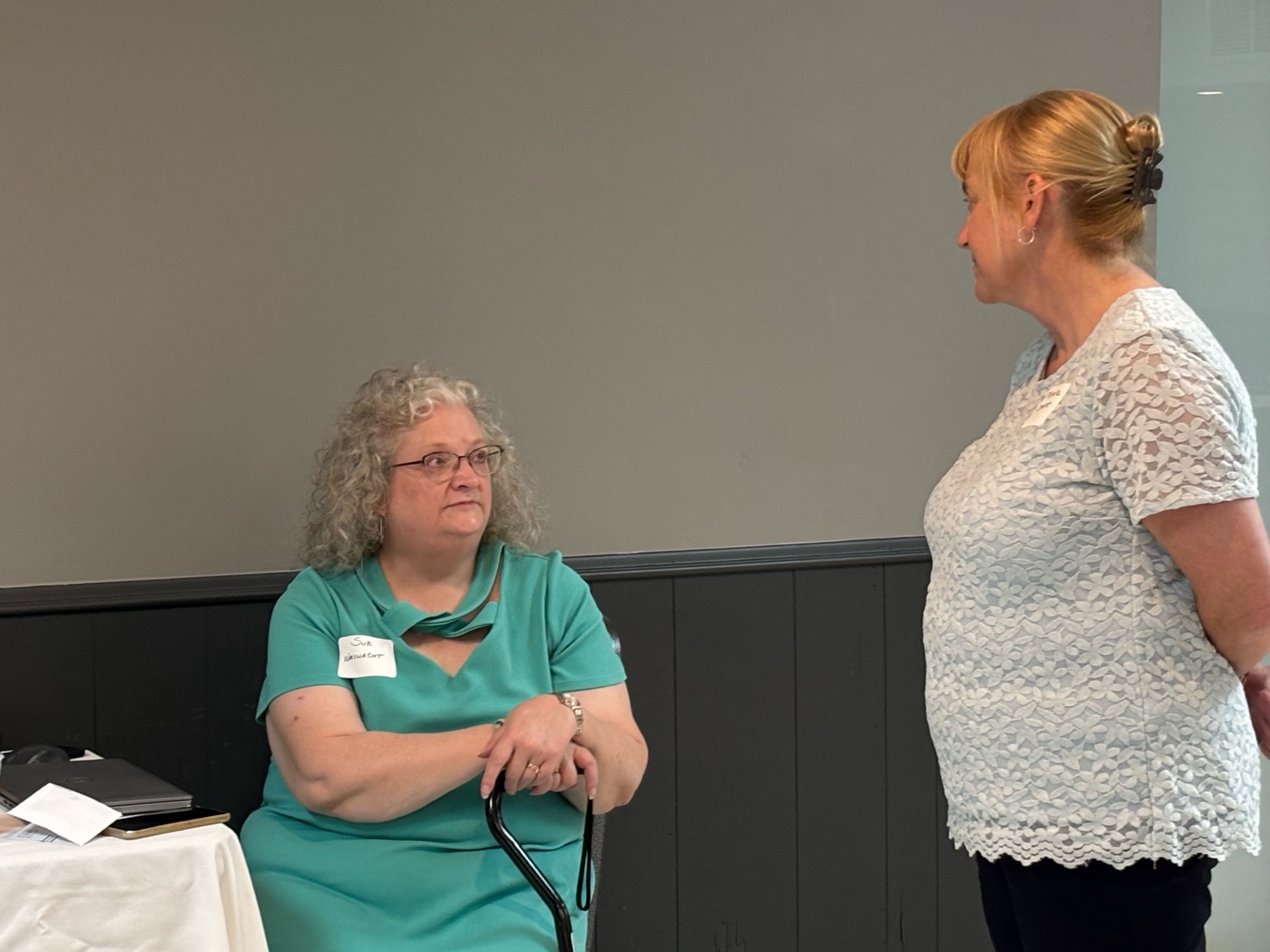 A person standing next to another person
AI-generated content may be incorrect.