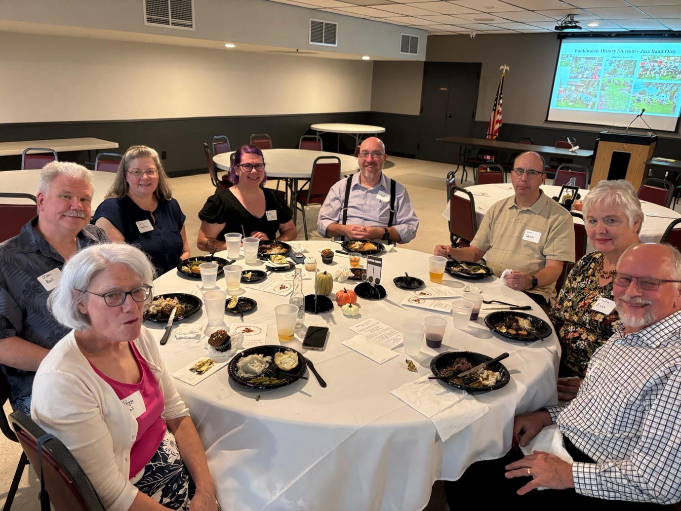 A group of people sitting around a table
AI-generated content may be incorrect.