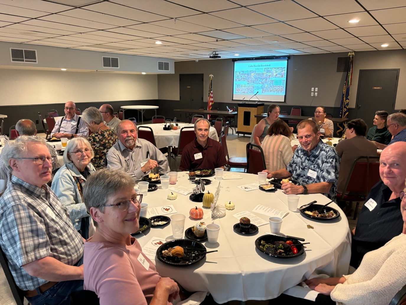 A group of people sitting around a table
AI-generated content may be incorrect.